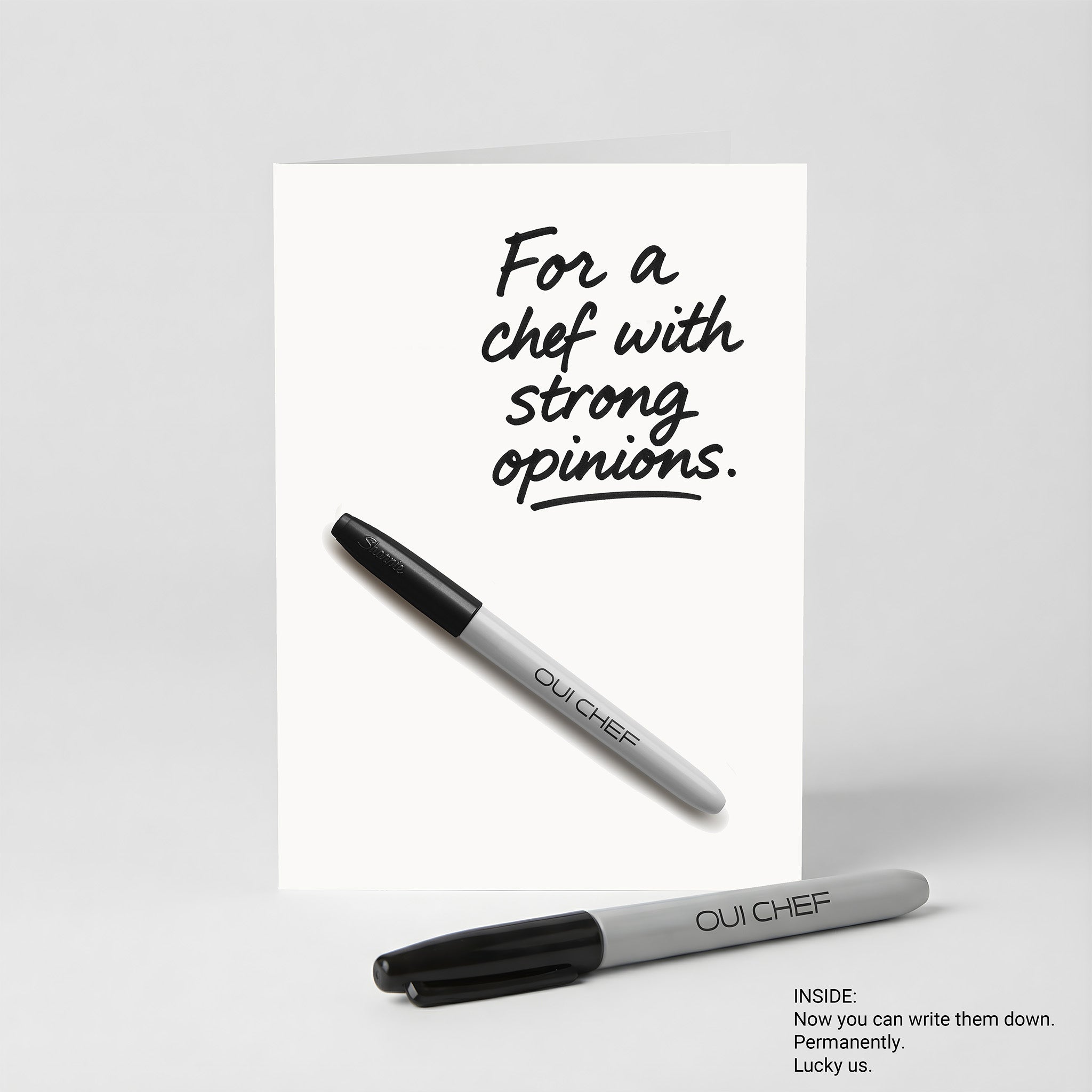 Oui Chef "Strong Opinions" Greeting card standing against a white background with a sharpie placed beside it.